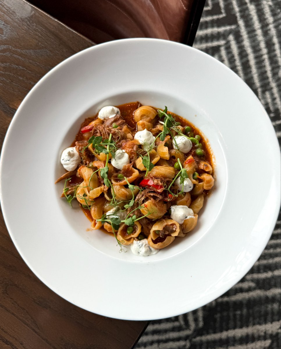 Elegance on a plate: Nesso Italian Kitchen's Orecchiette with braised lamb ragù, english pea, calabrian chili, mint, ricotta, and chili oil. ✨