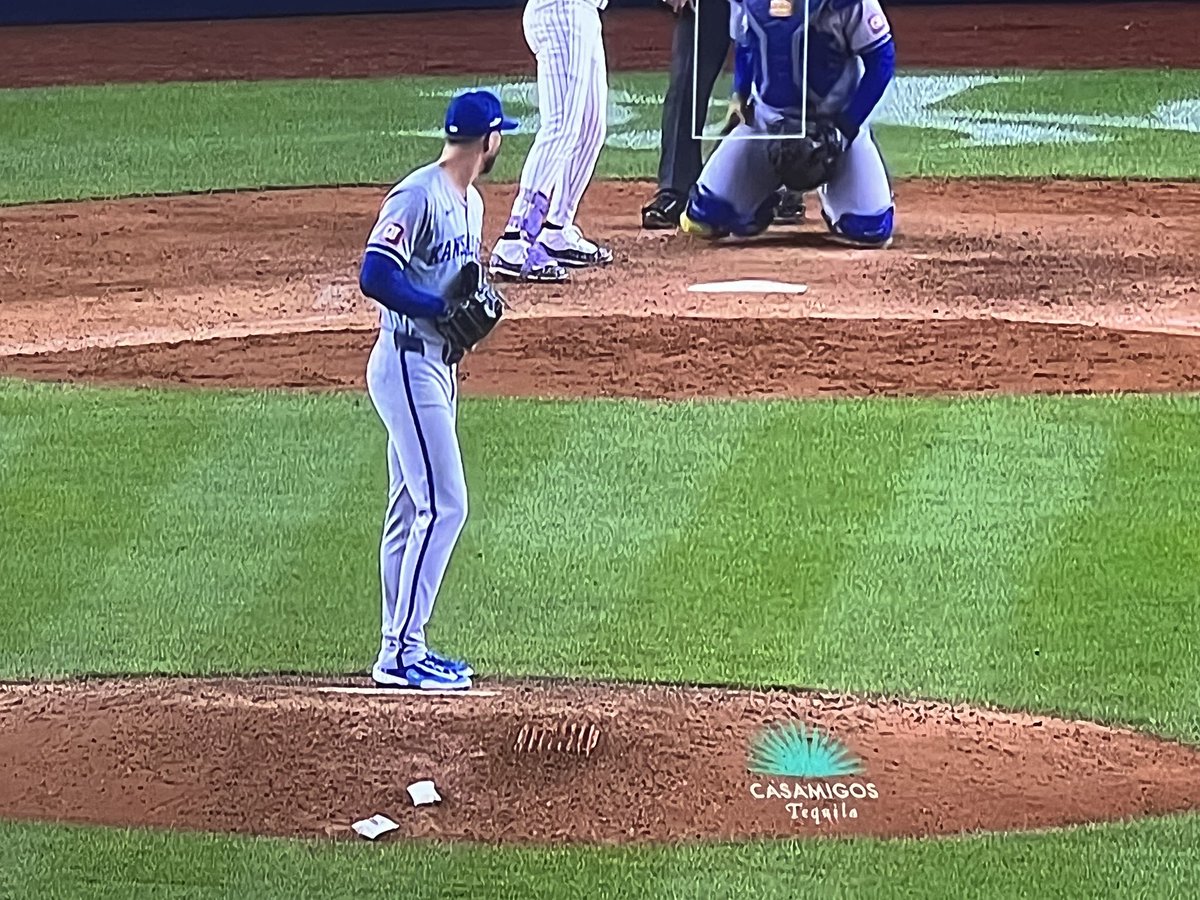 tequila ad on the mound with the closer who has his sobriety date on his glove
