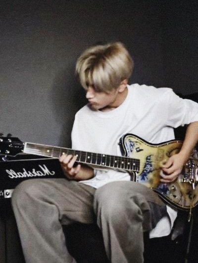 I’m gonna bring that youthful energy, strumming my guitar to my favorite song. With every chord, I’m ready to cast a spell and pull in anyone who’s watching or listening. And yeah, gotta say, the blonde hair only adds to the charm—so you better be ready to get lost in the vibe.