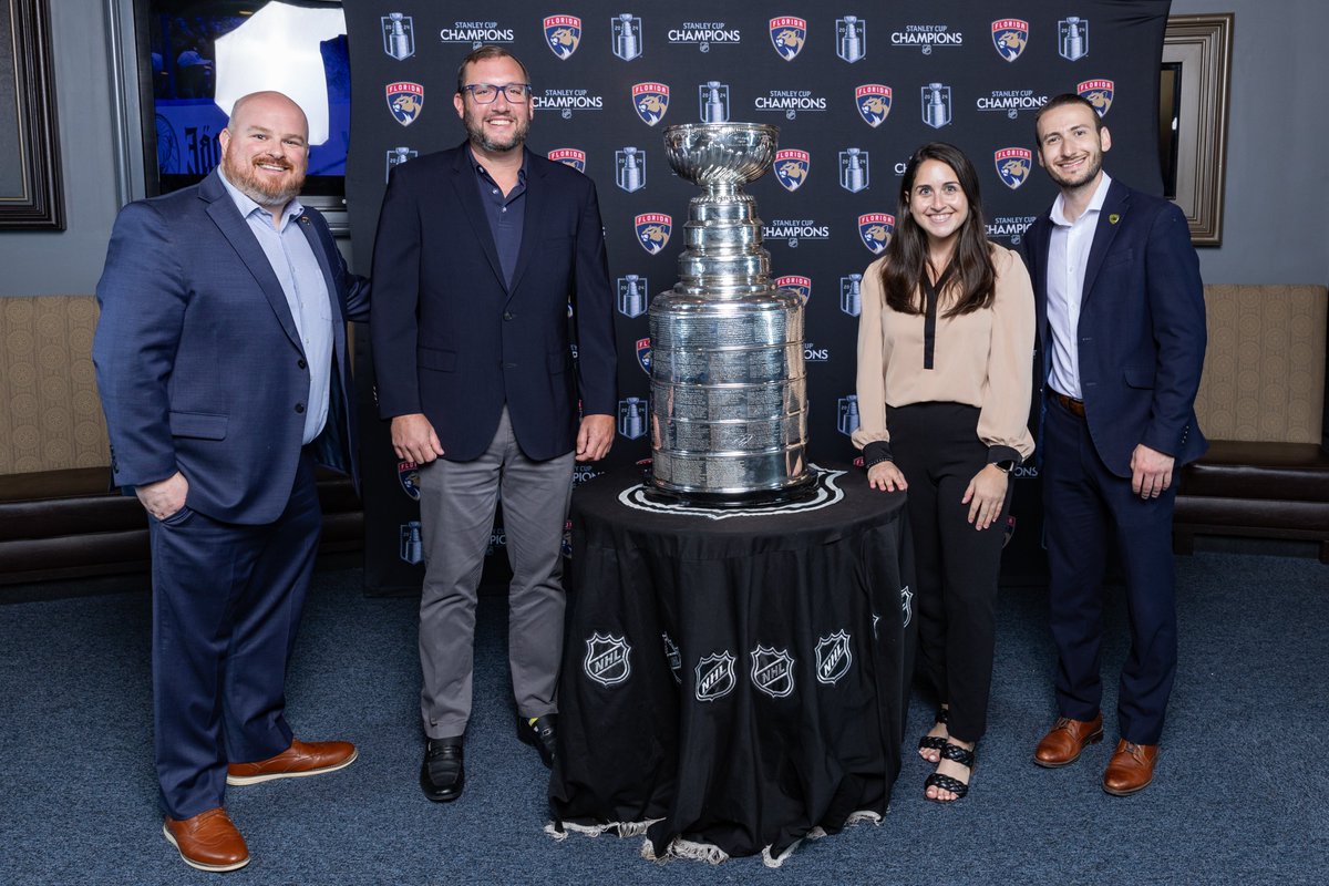 Miamilighthouse's tweet photo. Thank you to the Florida Panthers and the Panthers Foundation for inviting Miami Lighthouse to take a photo with the Stanley Cup. We congratulate the Florida Panthers on their big Stanley Cup win last season and are ready for a repeat Stanley Cup this season, as their first game starts tonight! 🏈🏆

Pictured, left to right-
John Colombo, Vice President, Florida Panthers Foundation & Community Relations at Florida Panthers
Cameron Sisser, Senior Vice President for External Relations, Miami Lighthouse for the Blind 
Danielle Jacobs, Foundation Director at the Florida Panthers
Matt Smith, Director, Community Relations at Florida Panthers

Together, we prove it's possible to see without sight! 💙 #MiamiLighthouse #SupportingtheBlind #Partners @FlaPanthers @FlaPanthersCARE

#FloridaPanthers #CommunityLeaders #MiamiLeaders #SupporttheBlind