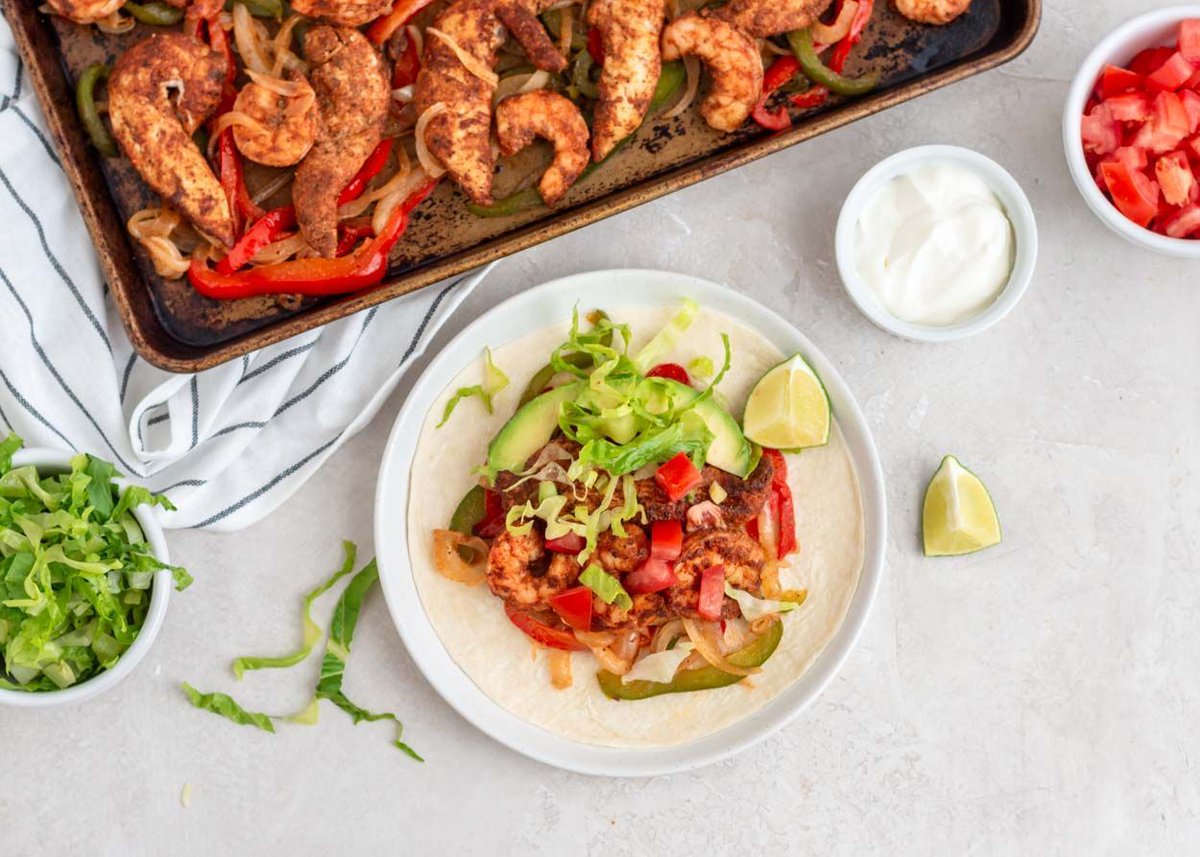 Sheet Pan Chicken and Shrimp Fajitas | Combo fajitas are a restaurant favorite, but they're easy and fast to make at home on a sheet pan. Put this crowd-pleaser into your Taco Tuesday rotation! | buff.ly/4evrCHg #mealplanmenu