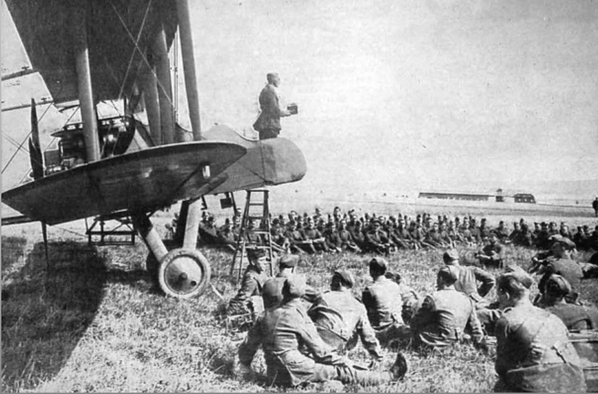 footsteps_pod's tweet photo. A British chaplain uses an FE2 as a pulpit to address his flock, Abeele, Belgium, 1917.  Find out more about Great War chaplains in our latest podcast - out Sunday #WW1 https://t.co/Ws2jFYjInm