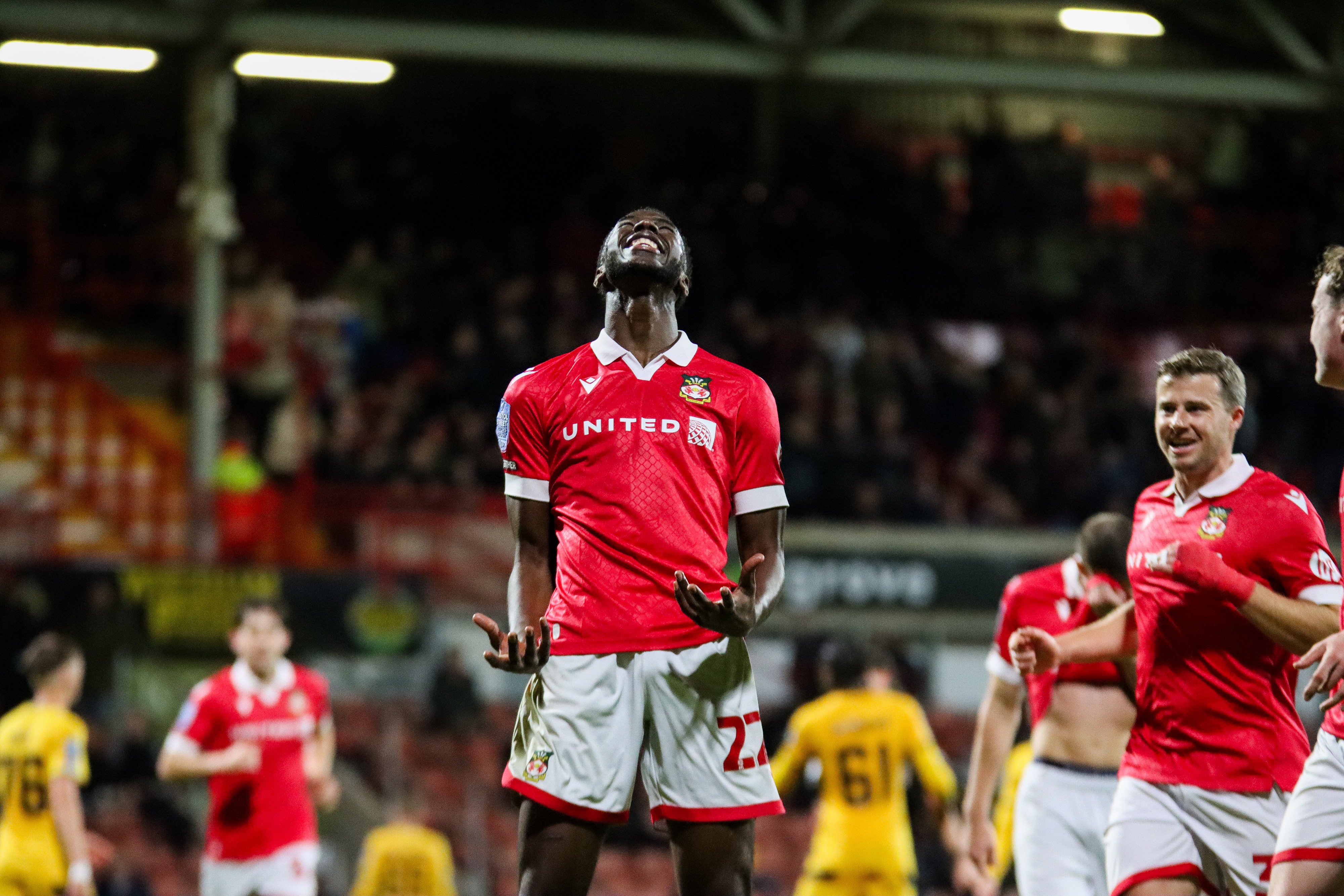 Mo Faal looks skywards, smiling, as he celebrates his goal
