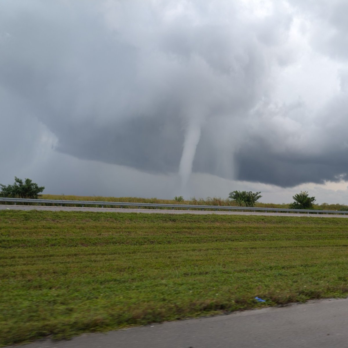 GCNNow's tweet photo. NBC2 viewer Kayon Walters captured a picture of this tornado that crossed I-75 (Alligator Alley) in Collier County Wednesday morning during Hurricane Milton. https://t.co/5KrHrEjuW7