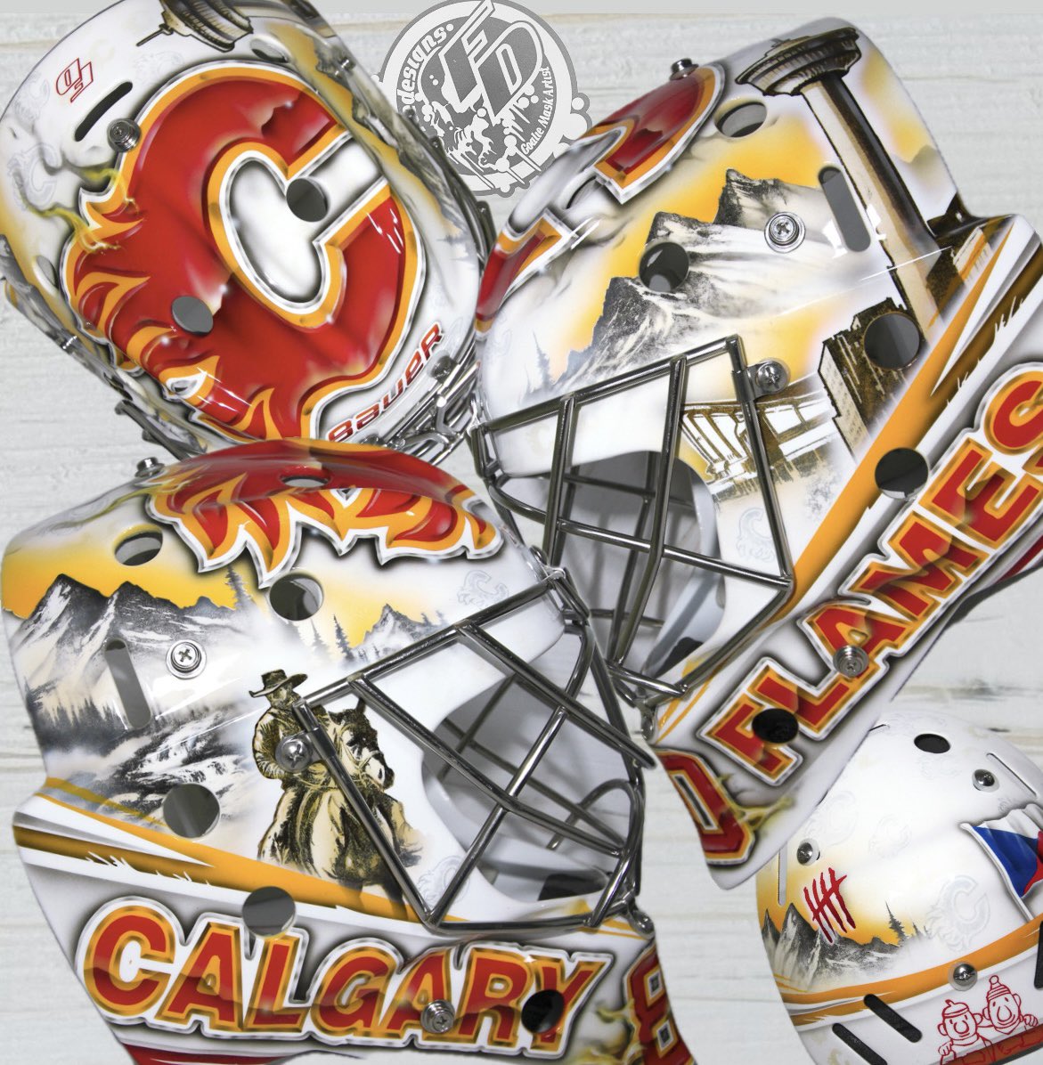 Friedesigns's tweet photo. New mask for @danvladar of the @NHLFlames he wanted a clean white based design. With the iconic mountain scenery and cowboy. And the #calgarytower had to be in there!  Thanks Dan, have a great season! 🔥🤘 https://t.co/um8sYWEQMh
