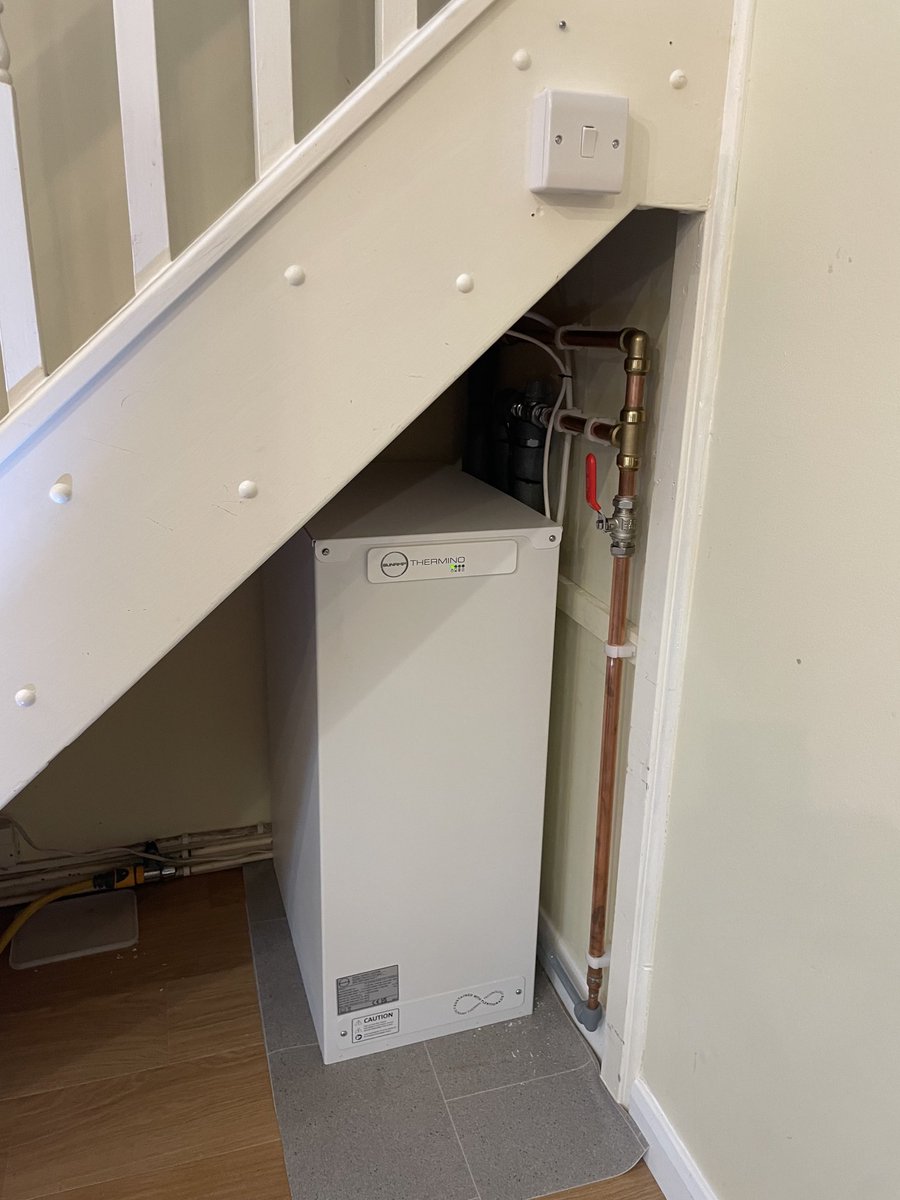 Another boiler vanquished. ⁦<a href="/SunampLtd/">Sunamp Ltd</a>⁩ under the stairs, client wants to put Perspex in front of it as it looks so good, wife not so keen! 210 litres of hot water heated by PV and overnight grid. #stopburningstuff #climatecrisis #efficiency