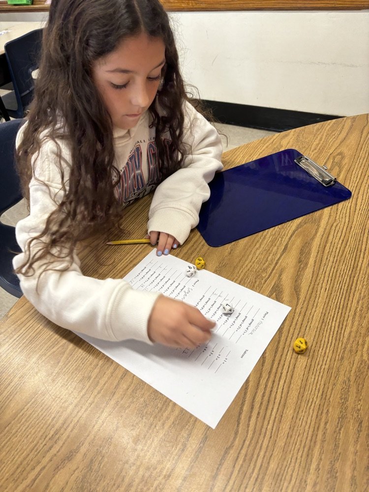 4D playing Yahtzee to practice multiplication.