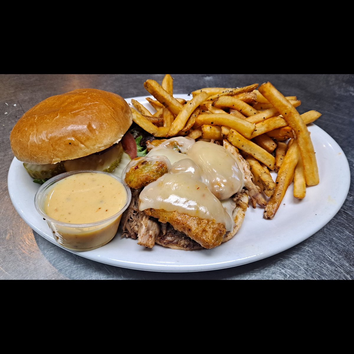 Weekly Food Special - Smoked Pork &amp; Avocado Sammie! It features our house-smoked pork and fried avocado with habanero jack cheese on a toasted bun, complemented by mixed greens, tomato, red onion, pickles, and peppercorn honey mustard. Accompanied by your favorite side item.