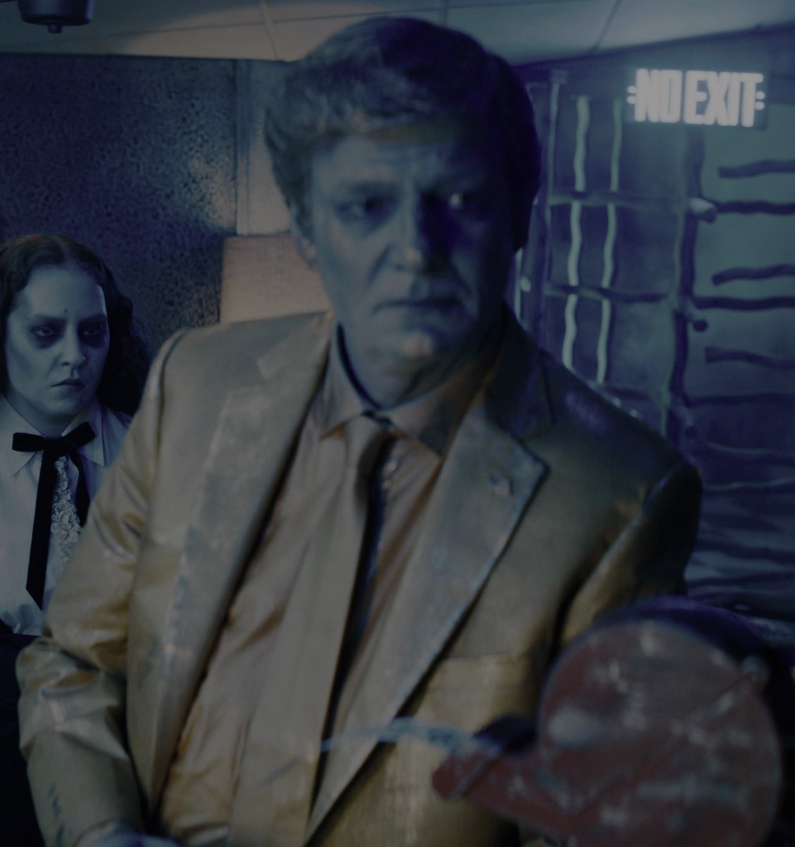 DanAughey's tweet photo. From Beetlejuice Beetlejuice (2024)....

A golden Donald Trump wearing a flag pin is stuck in-line in the afterlife. https://t.co/C711kn9Jxr