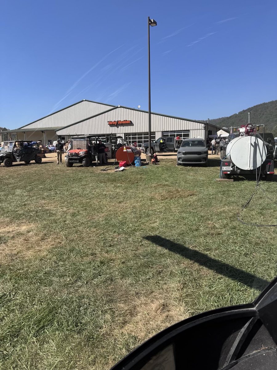 rallynate's tweet photo. Got back from North Carolina this week, wanted to post a recap.

We secured a helicopter over the weekend and flew/drove out with a truck and trailer loaded with supplies. 

After a dickhead state cop at Lake Lure, NC turned us away, we linked up with Sheriff Beam out of Lincoln County, NC and took off into the mountains from the supply hub at the Lincoln County airport. 

Ended up meeting some other helicopter teams doing some recon along the rivers and learned about a base at the Harley Davidson in Swannanoa, NC so we flew there to get fuel. 

Turns out that the Harley Davidson in Swannanoa was the main base where missions were being flown out of around Asheville. The guy running it was a former SOF Veteran and had it operating like a damn machine. 

Supplies were coming in and getting organized to go out, missions were coming in and going on a whiteboard to be assigned to each available team, was pretty cool to see it running. We plugged ourselves in and got to work. 

We flew a medic, batteries, and insulin to a lady near Clyde, NC that was on her last day. 

We flew doctors to a small church near Burnsville, NC to check on some old folks who were cutoff from leaving their homes. 

We were tasked with searching piles of debris that had been marked by cadaver dogs. 

We flew supplies up to another base up at the Elk River airport that needed help and ended up loading small planes, other helicopters, and truck/trailers that were moving supplies into the rural mountain communities.

National Guard was there with multiple helicopters and supply trucks but you could tell they were green and didn't know what to do. They listened to the Veterans that were running both the Swannanoa and Elk River bases. 

Only saw 1 FEMA team of a few guys with cadaver dogs, that was it.

99% of the people and assets there were from private citizens and Veterans.

On our last day we even had a guy meet us that flew from California, rented a suburban, and filled it with thousands of dollars in supplies...awesome to see people that still care about their fellow Americans.

Overall, the government has left the people of Western North Carolina and Tennessee to fend for themselves. 

One of the other helicopter teams was told by the Natl guard that Kamala Harris had the military load a plane full of supplies for a photo shoot and never sent the plane. 

Their response to this disaster is unforgivable.

Americans helping other Americans is the way.