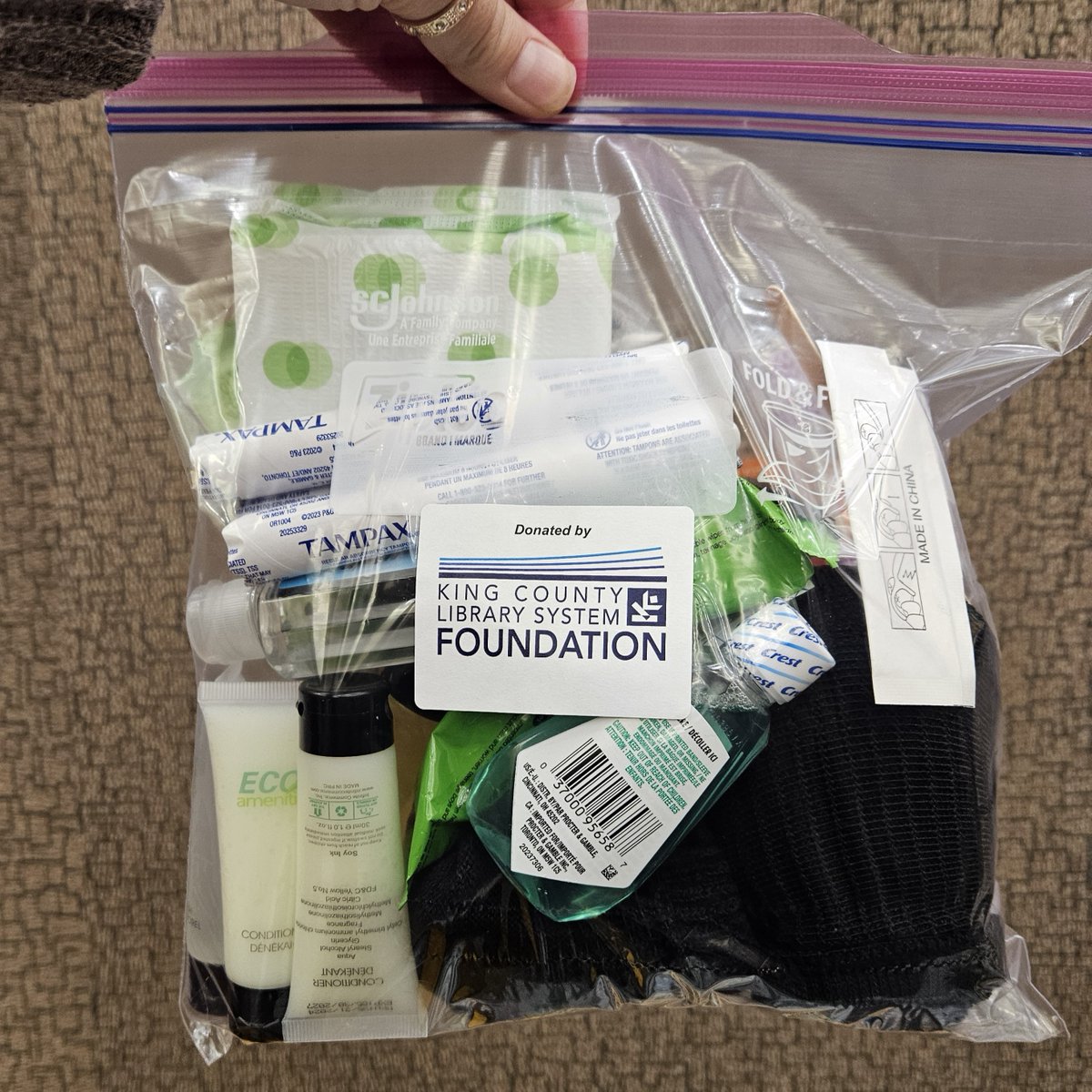 KCLSFoundation's tweet photo. Last week, a group of volunteers gathered to assemble 500 Hygiene Kits! These hygiene kits will be distributed at libraries, shelters, day centers and tent encampments to people experiencing housing insecurity throughout King County. https://t.co/IggZpLsf47