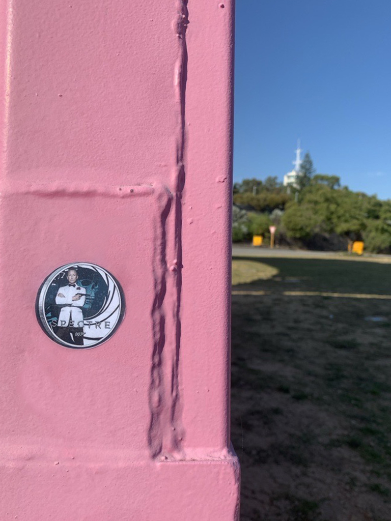Are you ready for the first clue in our scavenger hunt? 

Agent, your mission is set to unfold, where colours dance, both bright and bold. Near the river, not far away, a vivid array of containers is on display.
Good luck!