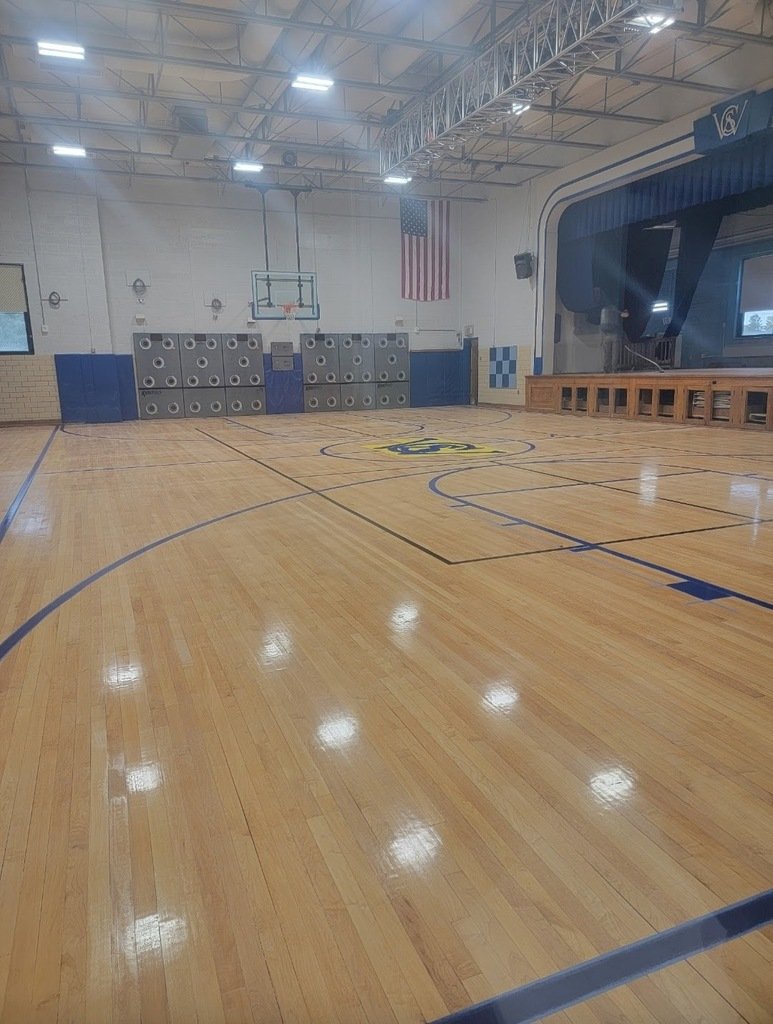 If floors could talk...  "According to my math, I've cut through about 100 layers of finish in there."  Our kids have enjoyed PE  back in the Small Gym this week after several weeks of hard work sanding and refinishing the floor and stage!