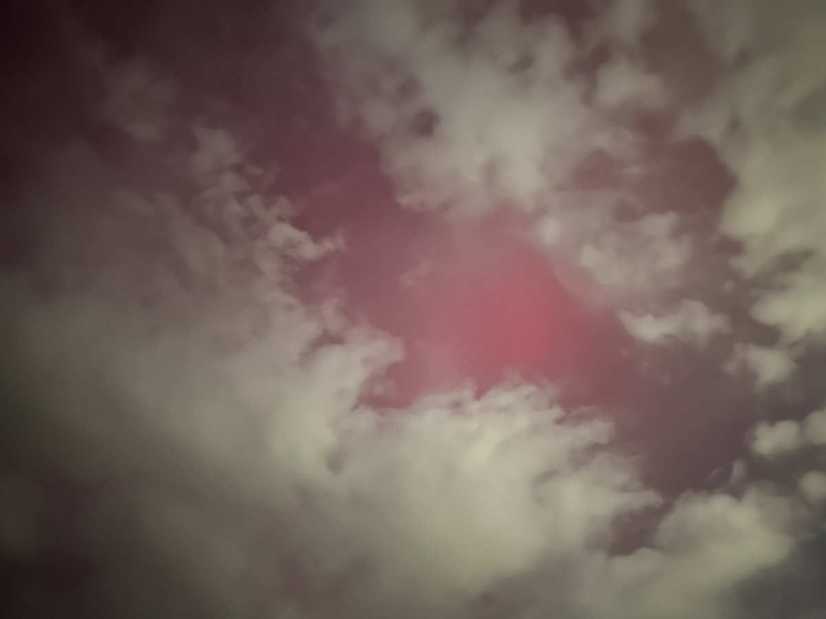 Northern lights peeking through the clouds on the front range