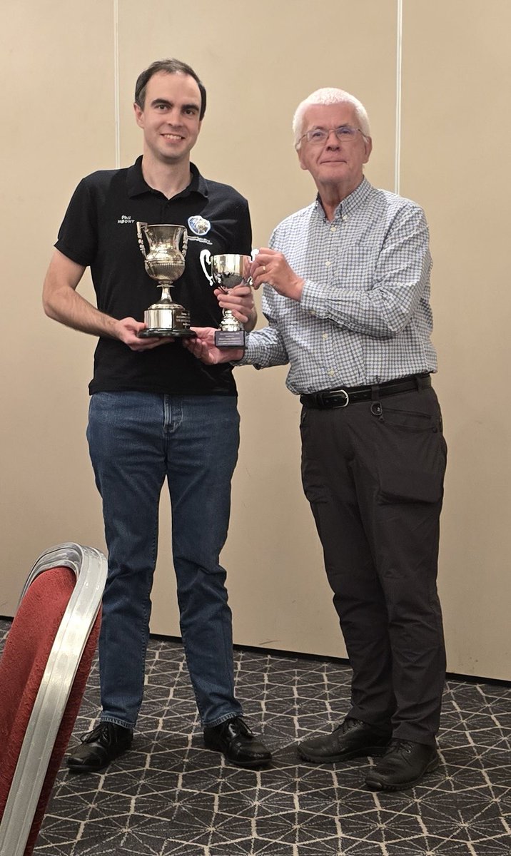 Phil Crump M0DNY receiving the <a href="/AmsatUK/">AMSAT-UK</a> G3AAJ cup from Dave Johnson, G4DPZ, HonSec A-UK for his outstanding services to the amateur satellite service