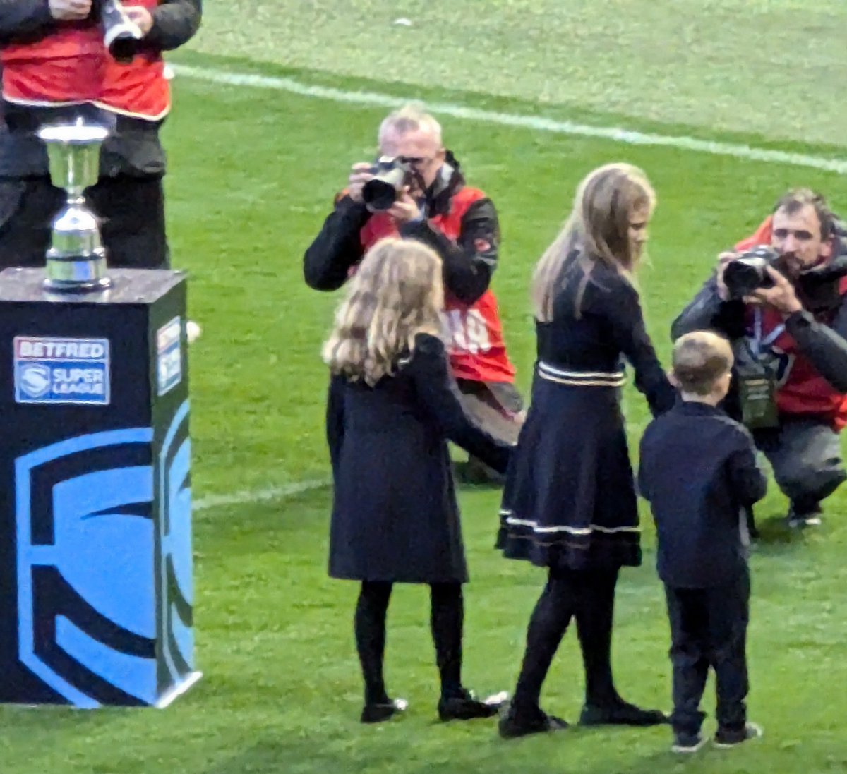 Jeans_Gems's tweet photo. The very moving image of the children of #RobBurrow (RIP) coming on the pitch @OldTraffFC π₯° Then Rob's Dad, Geoff bringing out The "Rob Burrow Award" π & the amazing #BevanFrench @WiganWarriorsRL being it's 1st Recipient ππFinally, Liam Farrell from @St_John_Fisher π« πππ https://t.co/AXrr2Bdezd