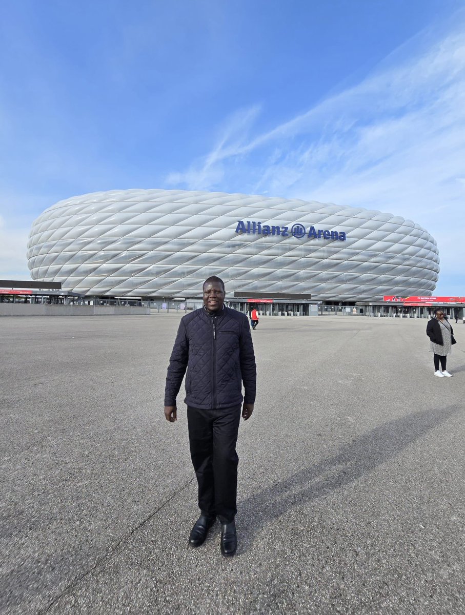 During my benchmarking visit to the Allianz Arena in Munich, Germany, the impressive size and facilities, such as 71,137 seats, 9,800 car parking spaces, catering facilities, kiosks, ticket counters, and a club museum, inspired me to push for modern stadiums in Gulu.