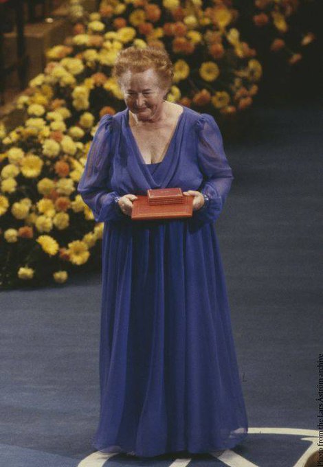 Gertrude Elion at the Nobel Prize Ceremony holding her medal and diploma.