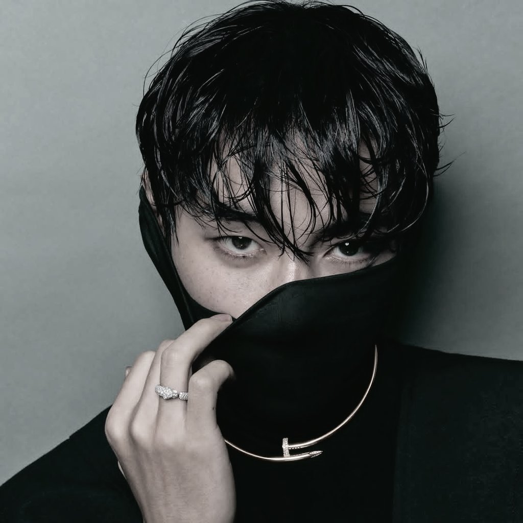 Toehynug's tweet image. Pierces through the veil with the quiet authority of old bloodlines reimagined for a new century; Cartier's diamonds whisper against the texture of ebony silk, catching fleeting starlight in their facets, while every controlled line of his expression speaks of power.