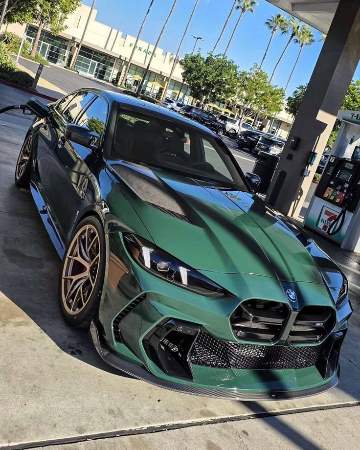 Getting a full tank for the Isle of Man Green beast. Those bronze wheels against the paint under the California sun just hit different. It is not just a car, it is a statement before the first gear is even engaged. 🌴