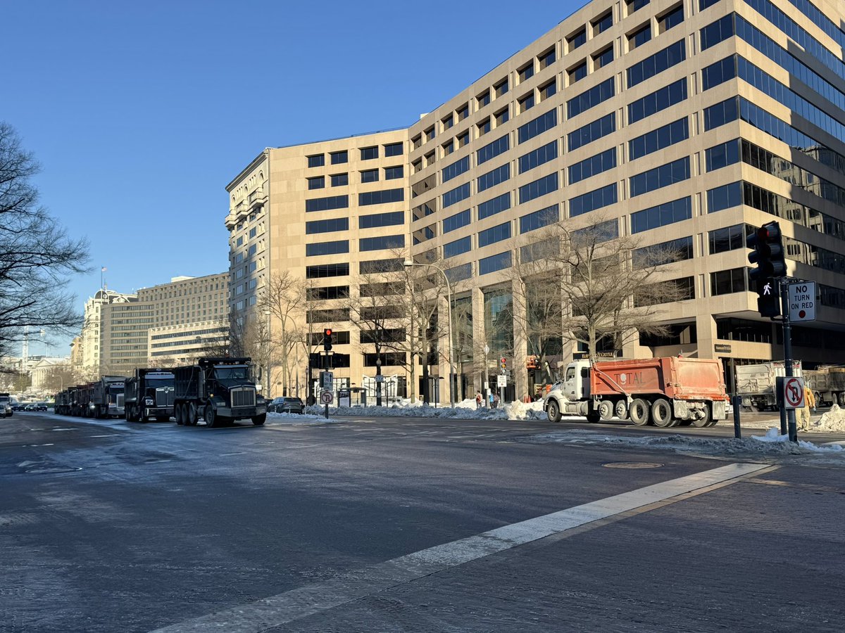 Trucks lined up and down Pennsylvania Avenue, ready to haul away the piles of snow on each corner. (At least 20 trucks not in the photo.)