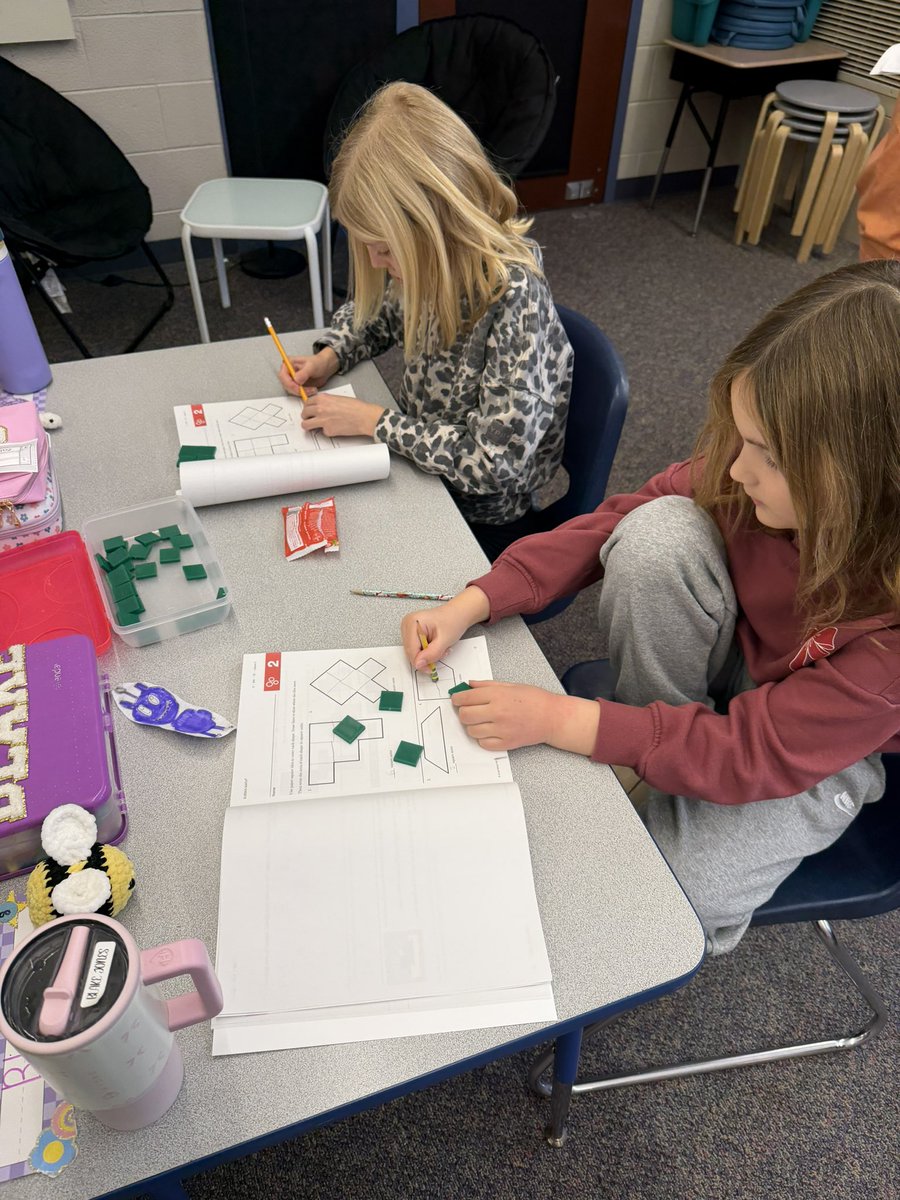 Using tiles to cover shapes to learn about Area in math today!