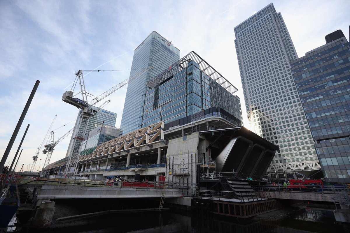 capbcon's tweet image. London built a major railway station inside a dock — and covered it with timber.

The Canary Wharf Elizabeth Line Station sits inside the former North Dock, constructed as a 300 m-long concrete box sunk into water, then capped with a ~4,500 m² laminated timber roof made from…