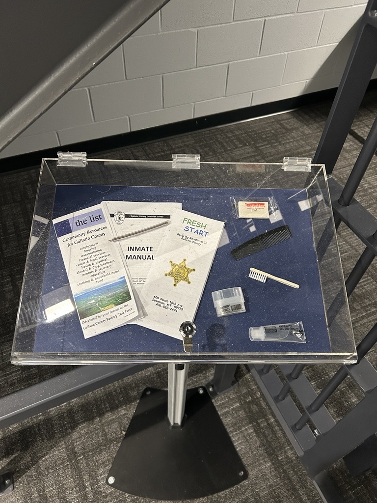 #DidYouKnow there’s a historic jail cell door in the BPSC? This door is from the 8-cell jail in the original downtown police and fire station, which opened in 1965. The display memorializes the former station, complete with door, chalkboard, and items issued to prisoners.