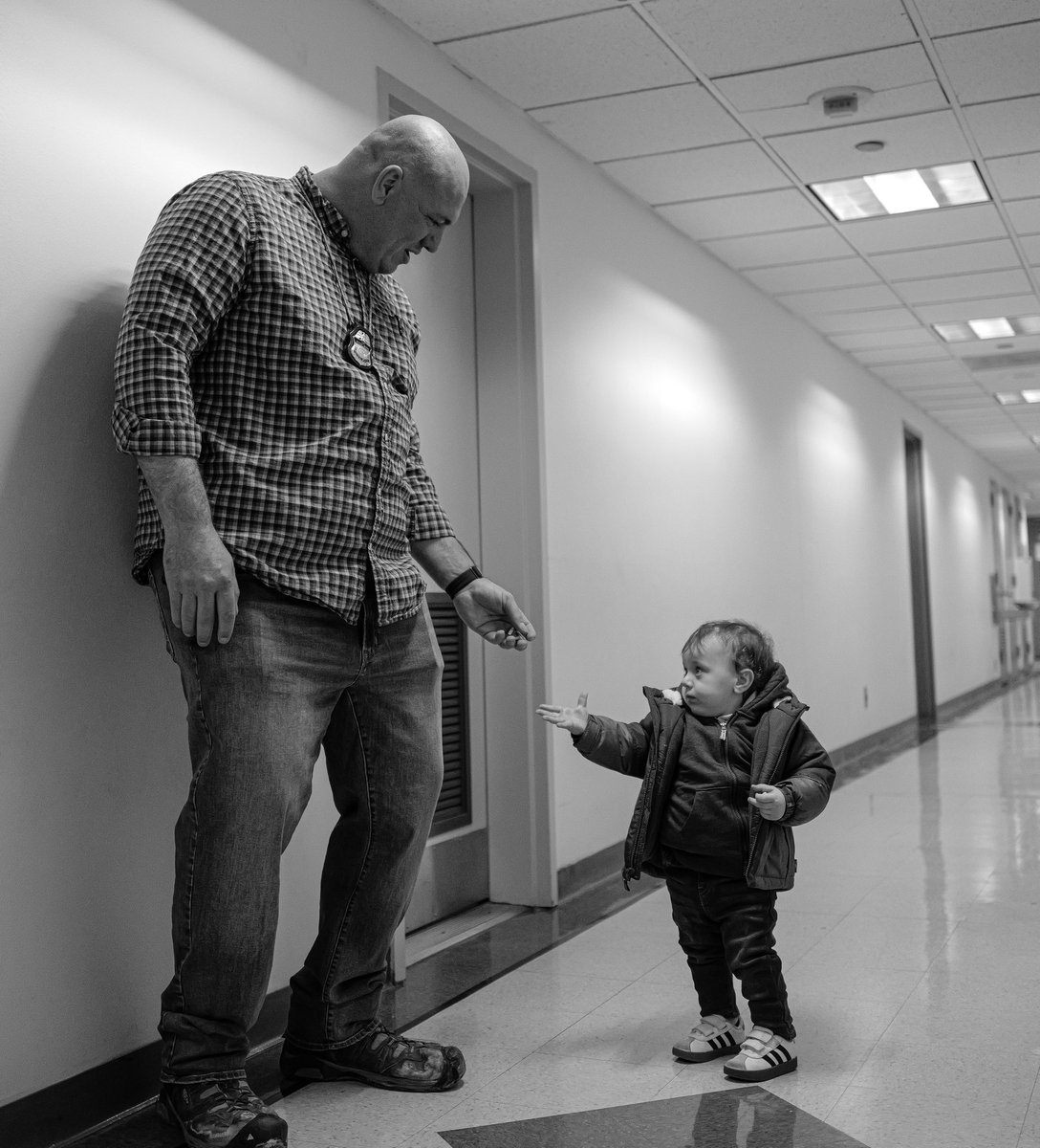 Dean_Moses's tweet photo. A moment of innocence in 26 Fed Plaza. A toddler wandered from a waiting room and offered an ICE agent candy,blissfully unaware of who his masked partners were, or why they were there. As life-altering choices are made around this boy his small hand offers a treat to a stranger. https://t.co/5DtcEPTuCM