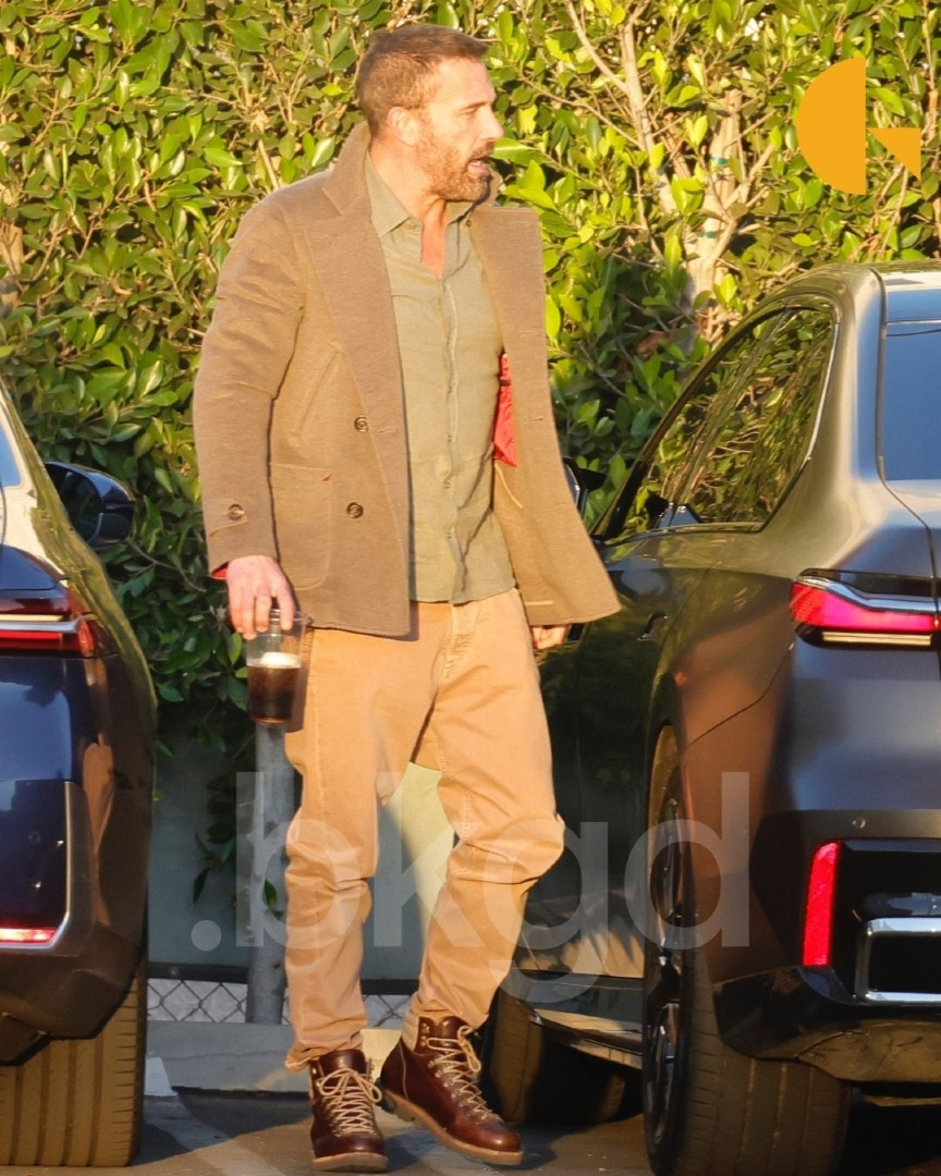 BackgridUS's tweet image. #BenAffleck was seen enjoying some father-son time with his son, Sam, in Los Angeles. Ben looked casually polished, holding an iced coffee in one hand while wearing a taupe overcoat layered over an olive green button-down shirt as he walked through a calm driveway area in the