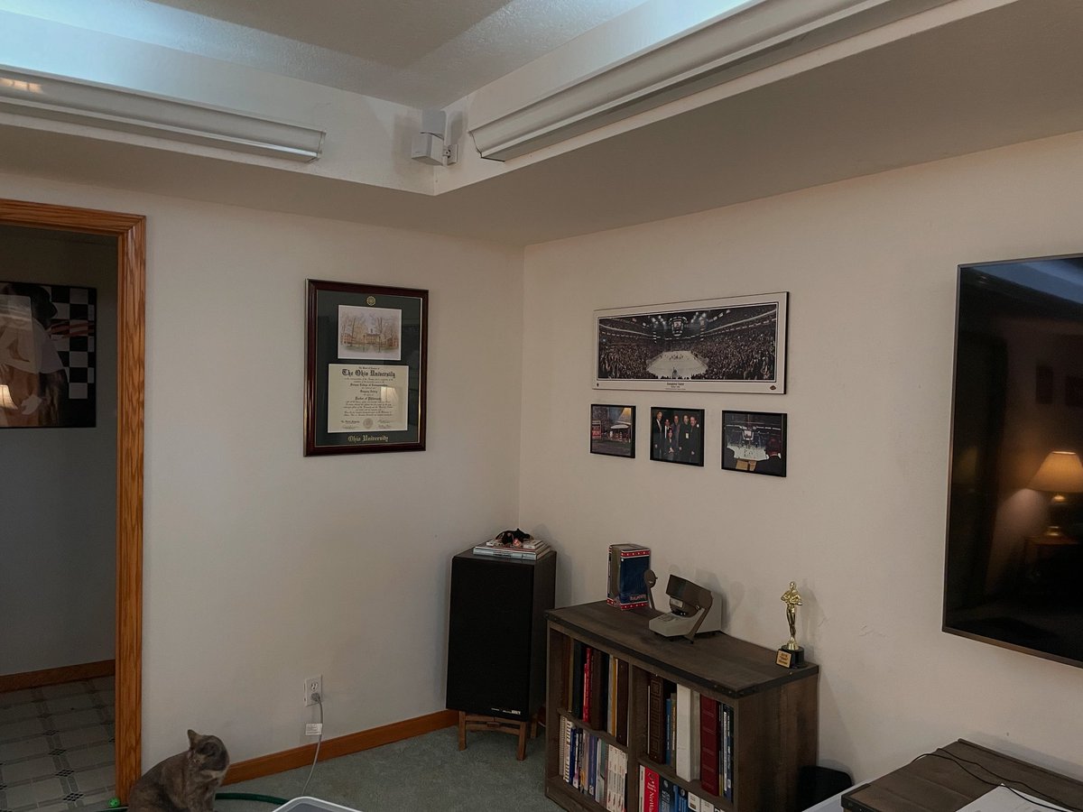 GregoryArdrey's tweet photo. After debating where to put the new diploma, I finally settled on putting it in the media room in the front left corner near my CBJ memorabilia.  The dark green matte in Ohio University colors goes well with the sea-foam green carpet and dark green sofas. https://t.co/9WusAVWgH3
