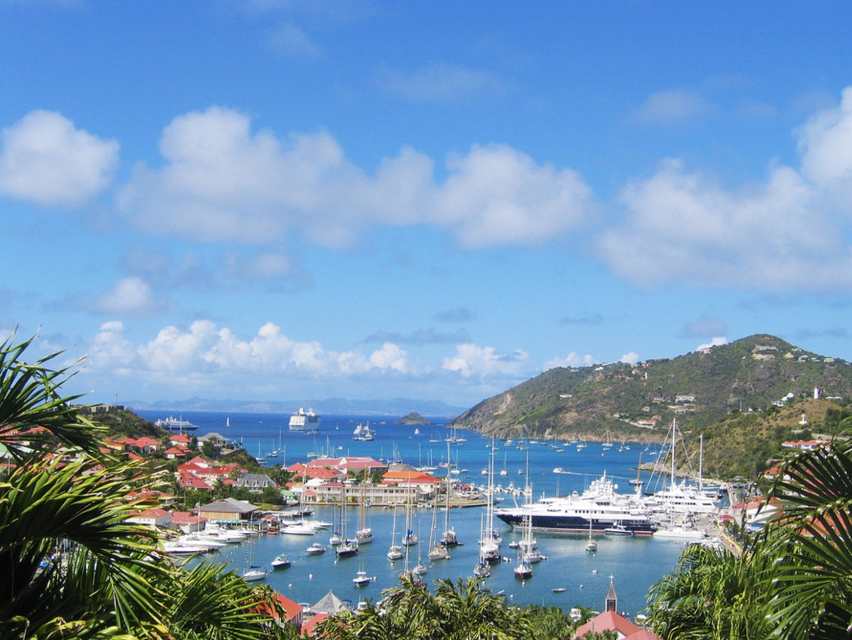 St. Barts: Experience the sweet life in this exclusive harbor where luxury meets a laissez-faire vibe. Contact JMart Travels today  to book your glamorous escape! #StBarts #LuxuryTravel #CaribbeanLife #YachtLife #BookYourGetaway #JMartTravels
