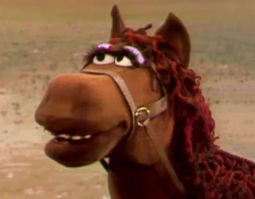GROVER: This town ain't big enough for the two of us.
FRED THE WONDER HORSE: I wanna say one word to you - plastics!

Happy Lunar New Year, Muppet Fans! Enjoy the year of the horse!