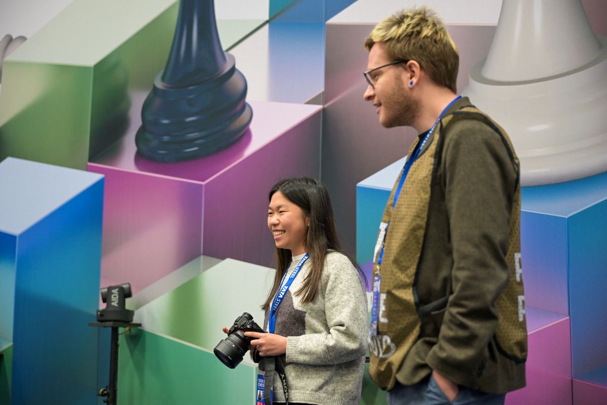 ChessBase's tweet photo. ♟️📸 Even while battling the Challengers @tatasteelchess, @carissayipchess finds time to get behind the lens!

Quick question though… did she borrow that camera from @LennartOotes ? 😄

Grandmaster moves and photographer vibes.

#Chess #WijkAanZee #ChessLife #ChessTwitter https://t.co/aC0Ah3KAQW
