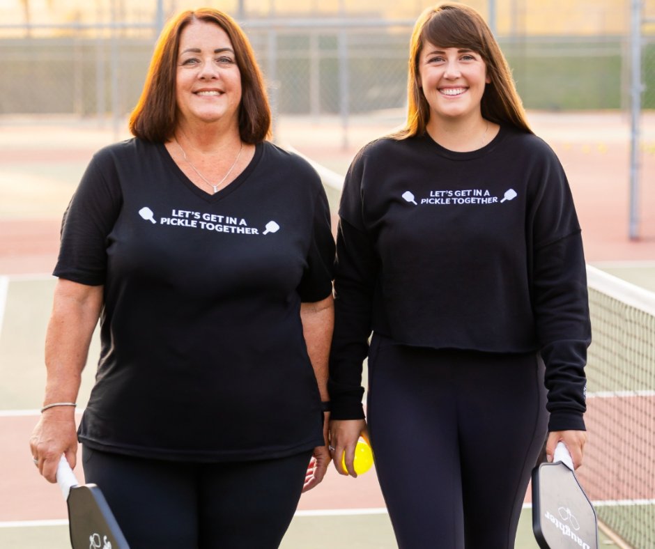Cozy sweatshirts like this one from The Pickle Together Collection are designed for comfort, warmth, and everyday wear, perfect for cool mornings at the courts or laid-back days off. Soft, relaxed, and full of pickleball pride, every piece reflects the energy and community behind
