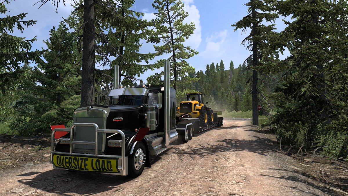 Dkasper00's tweet photo. Just a W900 hauling wheel loader in the woods.  @SCSsoftware 
#AmericanTruckSimulator 
#BestCommunityEver https://t.co/vxt0GlwhYE