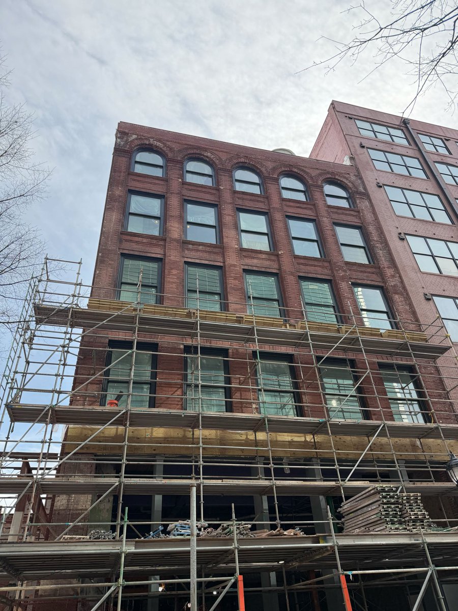 85 Peachtree facade on Broad St starting to emerge from its scaffold.