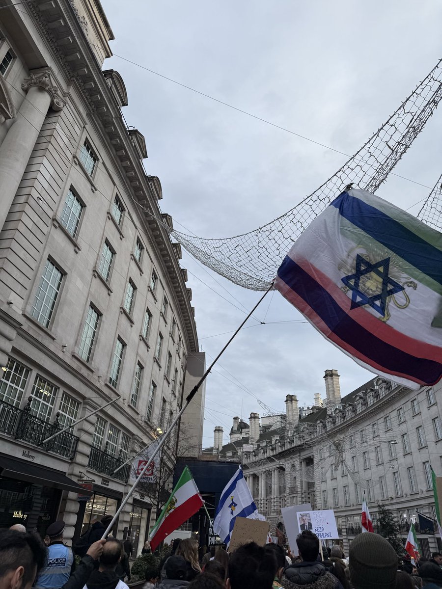 MaxBlumenthal's tweet image. Flags of the genocidal Israeli regime are almost as prominent at daily London rallies for “freedom” in Iran as the monarchist flag

Is it any wonder the world fails to find inspiration in this pro-war movement?