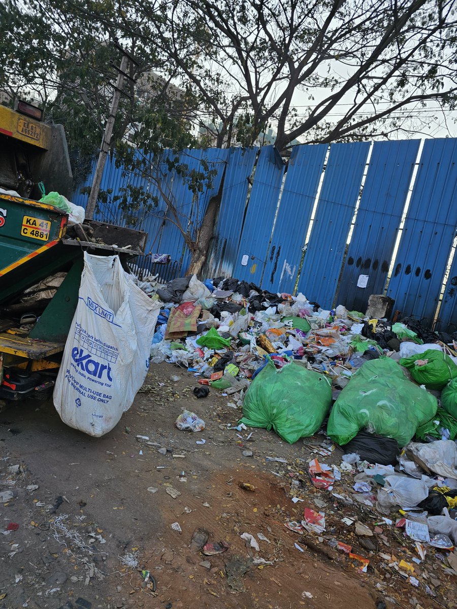 ppbharath's tweet photo. Shocking state of waste management by @BbmpEast . During transfer from small vehicles to lorries, excess waste is just dumped on the roadside and left there. This isn't "cleaning," it's just moving the mess -infront of Gopalan enterprises TC Palya signal. 
@bbmpcommr https://t.co/G2yeDuJ70o