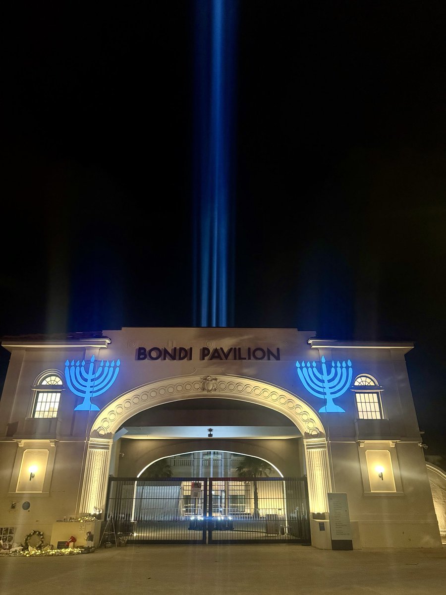 Ostrov_A's tweet photo. As the National Day of Mourning for the Victims of the Bondi Attack draws to an end, a light shines bright from the Bondi Pavilion, in a powerful reminder that #LightWillWin! https://t.co/W6BySVFlvb
