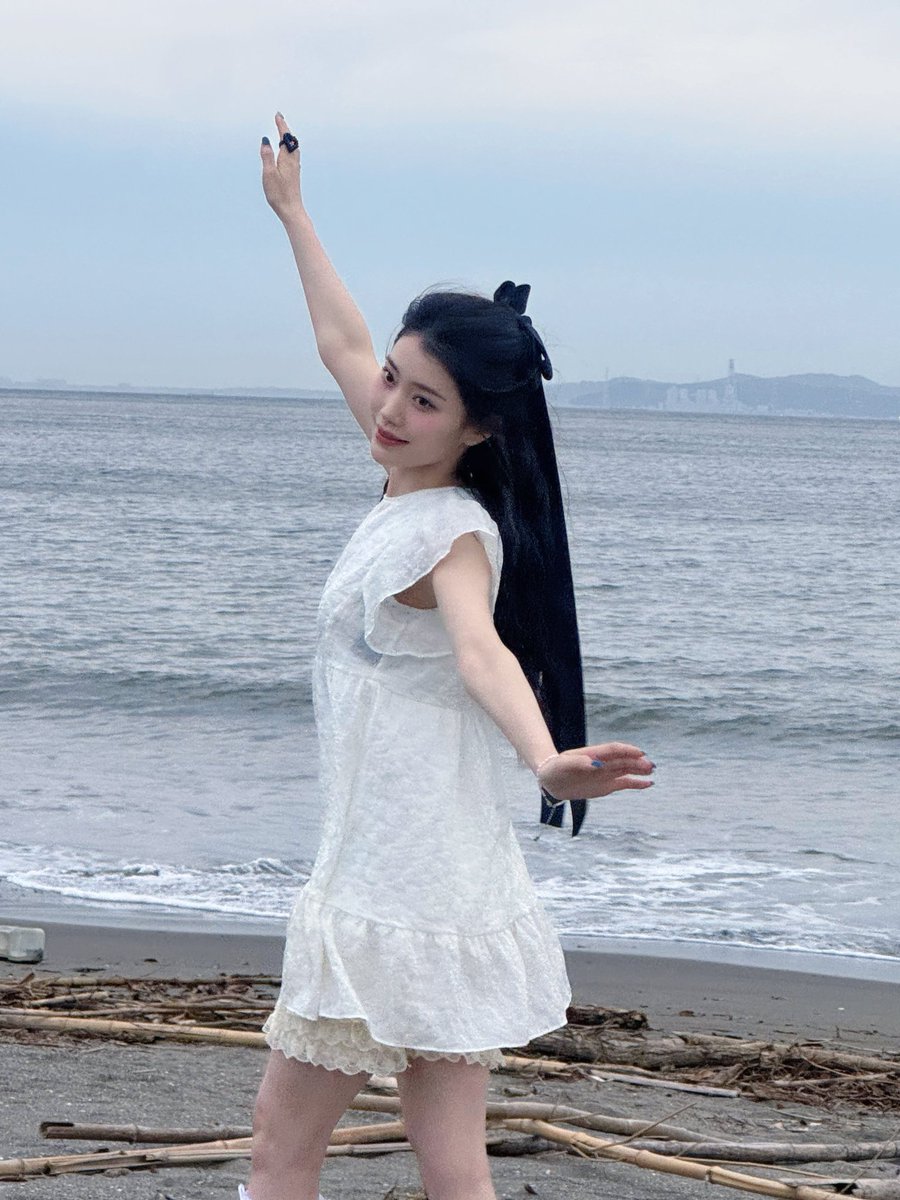 xiaotuing's tweet image. I stand a little taller, letting the sea air pass softly.  

𖦹°·𓇼 This higher angle keeps my expression clear and steady. Behind me, the shoreline stretches wide, with distant shapes resting far away, giving space to breathe, smile softly, and enjoy a slow summer pause.  ⋆˚࿔