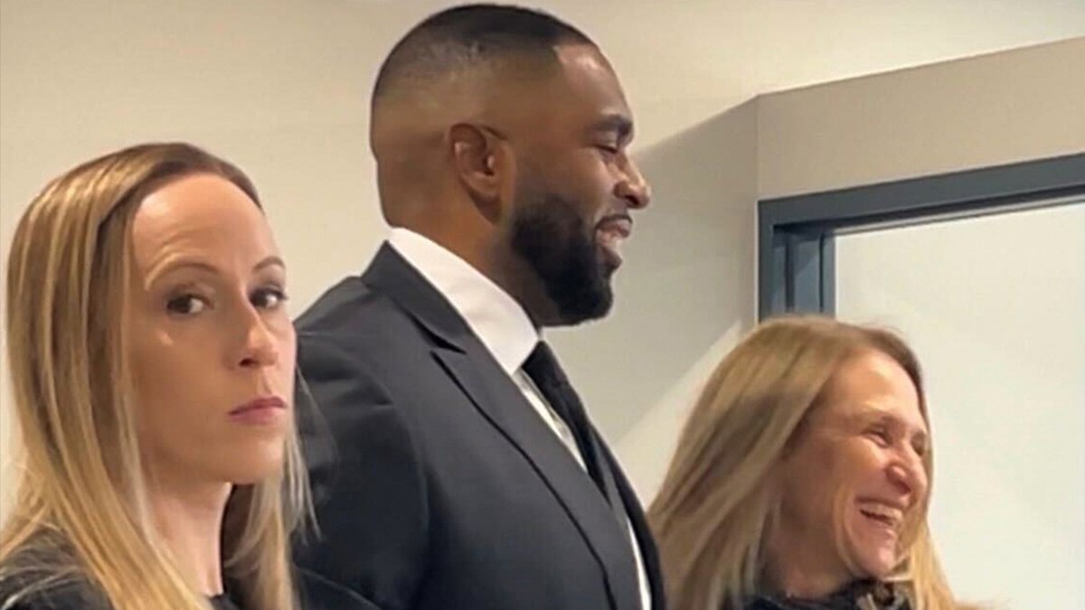 TMZ's tweet image. Sherrone Moore is all smiles ahead of his court appearance with his wife by his side. tmz.me/NdvvzZG