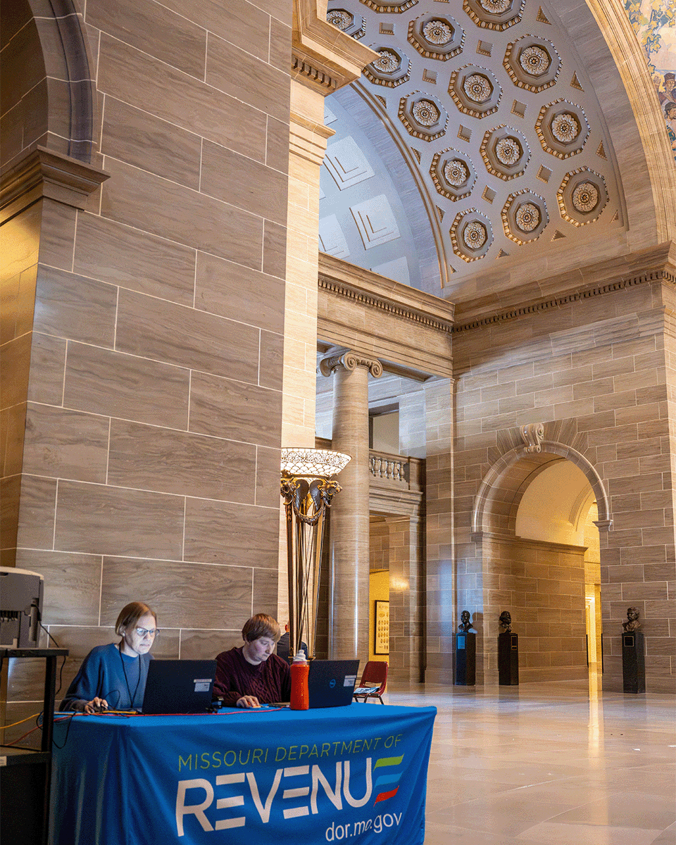 DOR Employees in action — To provide a convenience for our Missouri legislators and elected officials, DOR has been set up at the Capitol to help elected officials register their legislative district specialized plates during designated booth hours.