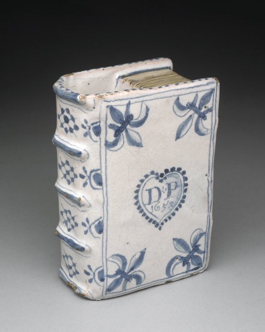 jdmccafferty's tweet image. Ornament (perhaps a hand-warmer or flower holder), tin-glazed earthenware, moulded in the form of a book, 1658 from #Southwark (BM)