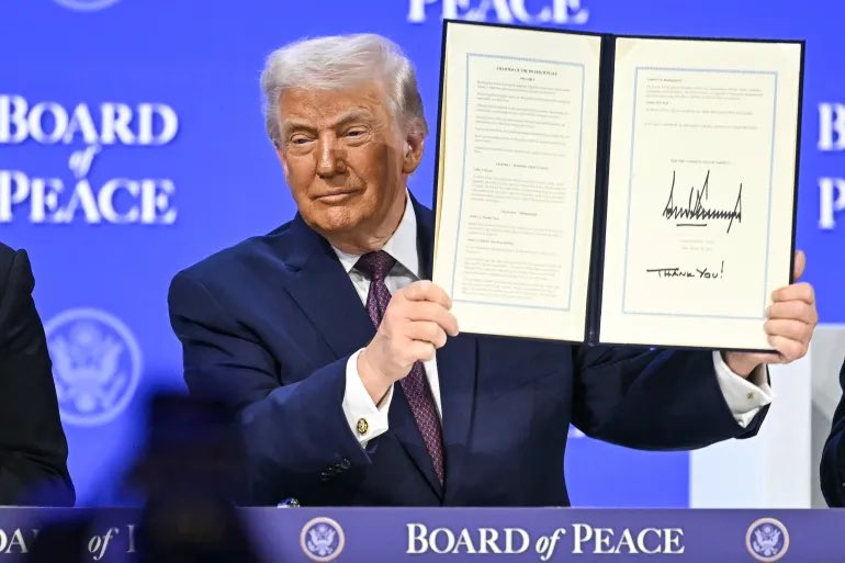 shanaka86's tweet photo. Belgium was listed as a Board of Peace signatory at Davos.

Belgium immediately denied signing.

This is Davos 2026 in one sentence.

Trump announced a Greenland “framework deal” with NATO Secretary General Rutte.

Danish PM Frederiksen’s response: “Rutte has no mandate to negotiate on Denmark’s behalf.”

Trump negotiated Greenland with someone who doesn’t own Greenland.

Greenland’s own Prime Minister when asked what’s in the deal about his country:

“I don’t know what there is in the agreement, or the deal about my country.”

Then came the Board of Peace.

An 11-page charter for Gaza reconstruction.

The word “Gaza” appears zero times.

Trump’s exact words at the signing:

“Once this board is completely formed, we can do pretty much whatever we want to do.”

Sole veto power. For life.

Authority over any global conflict zone. Worldwide.

$1 billion membership fee. Per country.

Power to nominate his own successor.

Russia offered to pay using frozen Western assets.

Trump: “I’m fine with that.”

25 nations reportedly signed.

France refused.

Belgium denies signing.

The pattern:

Negotiate with parties who don’t own the asset.

Sign charters that omit their stated purpose.

List signatories who deny signing.

Declare victory before anyone reads the document.

And the markets moved anyway.

Critical Metals stock pumped 158% in three weeks on Greenland headlines.

The 1951 Defense Agreement already gives America base rights in Greenland. In perpetuity.

Trump negotiated access to something America has had since Truman.

But the stock moved.

The headlines printed.

The institution now exists.

Everyone debating whether Trump “failed” at Greenland is measuring the wrong variable.

The 20th century required signatures.

The 21st century requires announcements.

Treaties needed consent.

Press releases only need attention.

Mark Carney stood at the same podium and delivered the verdict:

“This is not a transition. This is a rupture.”

He wasn’t describing a failure.

He was describing an upgrade.

The old operating system required agreement to execute a deal.

The new one just requires the headline.

Davos 2026 wasn’t a negotiation.

It was a product launch.

The announcement is the product.

The deal was never the point.​​​​​​​​​​​​​​​​

https://t.co/UUSvx41OJI