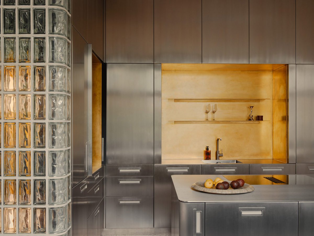 dezeen's tweet image. Steel-panelled fireplace forms heart of Emiel Vercruysse's renovated 1950s townhouse: dezeen.com/2026/01/23/ber…