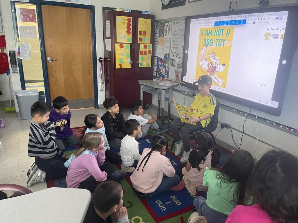 BPD3HW's tweet photo. A student in Mrs. Nunez’s second-grade class practices a read-aloud for peers as he prepares to read to a kindergarten class. What a great example of leadership and growing literacy skills! #HoweBears #LearnLeadSucceedBPD3 #studentleaders https://t.co/Y9M6z2Ryys