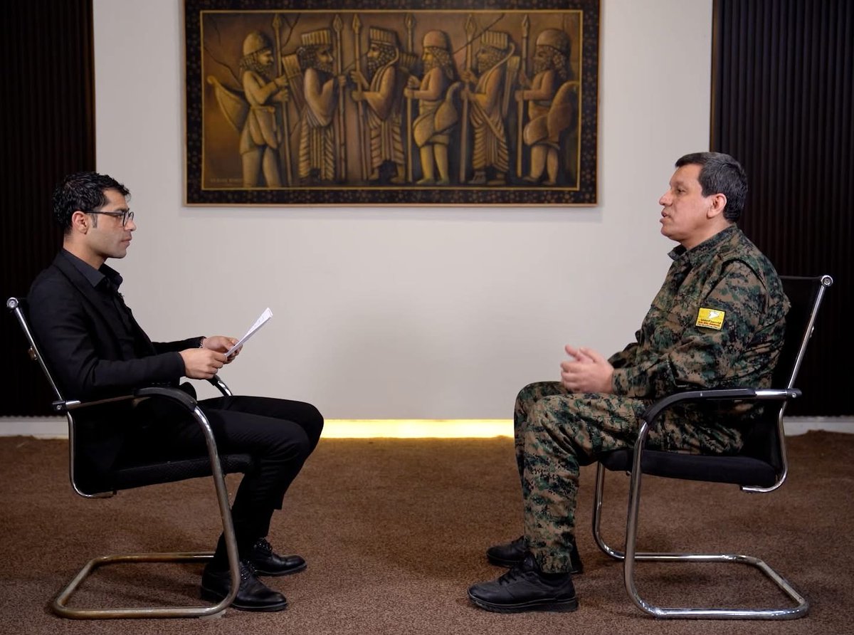 It is interesting to note that SDF's Mazloum Abdi has frequently appeared in recent interviews with this specific painting prominently displayed on his wall. The artwork depicts the 'Immortals,' the elite royal guard of the Achaemenid Empire (c. 550–330 BC).

This choice of decor