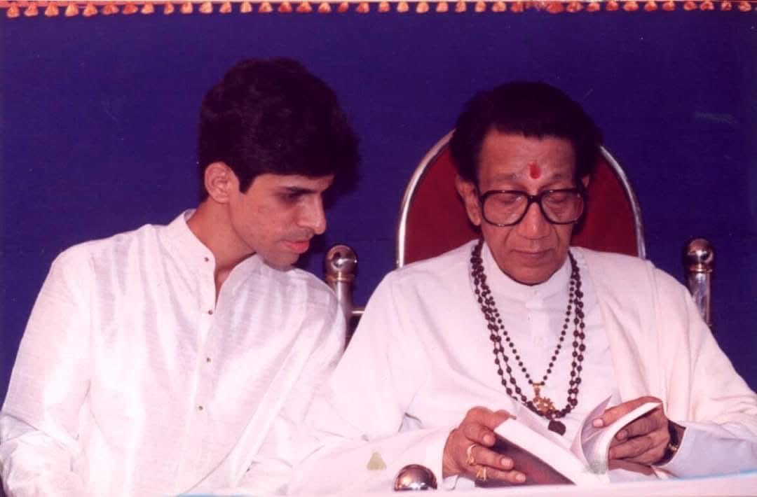 With Balasaheb Thackeray, once upon a time. He’s looking at a book I have written, and I am checking which page he’s on.