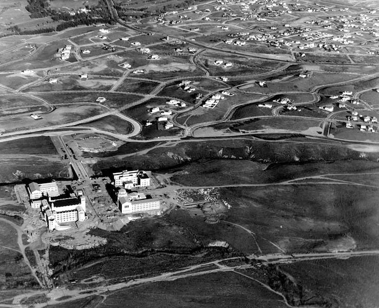 Aerial view looking east across UCLA while the campus was under construction, Westwood,  1929. Only 5 buildings so far: Royce Hall, Powell Library, Haines Hall, Kinsey Hall, and the Bridge. But look at all that empty land. It must have been like driving through the countryside.